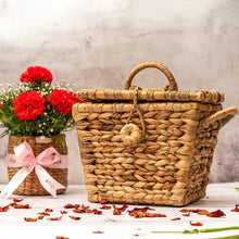 Load image into Gallery viewer, A close-up view of a handwoven wicker creel basket with a natural brown color and a classic design. The basket features a woven lid and a large opening for storing items. The wicker material is tightly woven, with a few gaps for ventilation, and the basket has a sturdy, structured shape. Two handles on either side allow for easy carrying. This wicker creel basket is a versatile and stylish storage solution for a variety of items, with a rustic and functional design