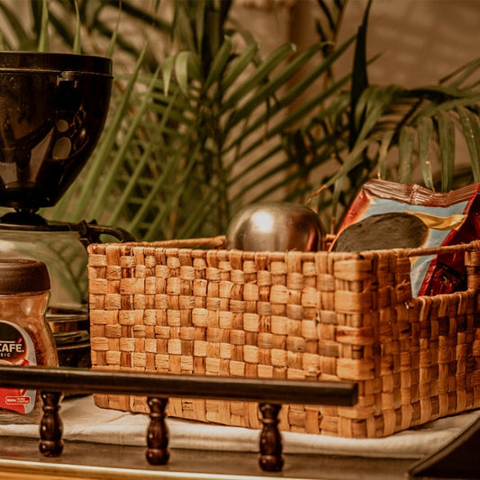 Image of a wicker single checks basket with a unique weave pattern and sturdy metal frame. The basket has a natural woven texture and side slots for easy handling